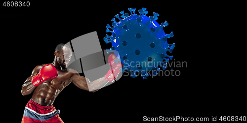 Image of Professional sportsman kicking, punching coronavirus model - fight the desease, flyer