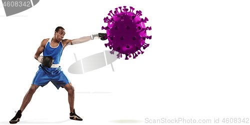 Image of Professional sportsman kicking, punching coronavirus model - fight the desease, flyer