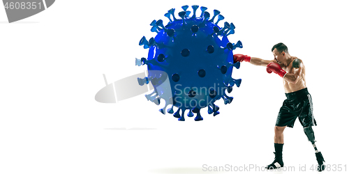 Image of Professional sportsman kicking, punching coronavirus model - fight the desease, flyer