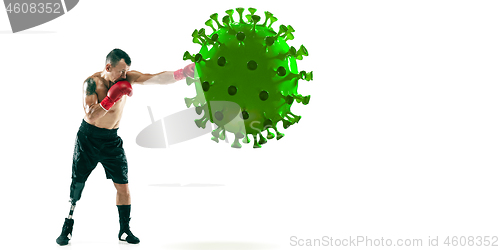 Image of Professional sportsman kicking, punching coronavirus model - fight the desease, flyer