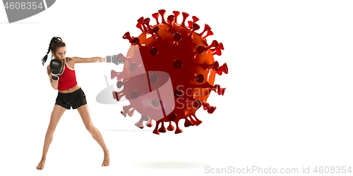 Image of Professional sportswoman kicking, punching coronavirus model - fight the desease, flyer