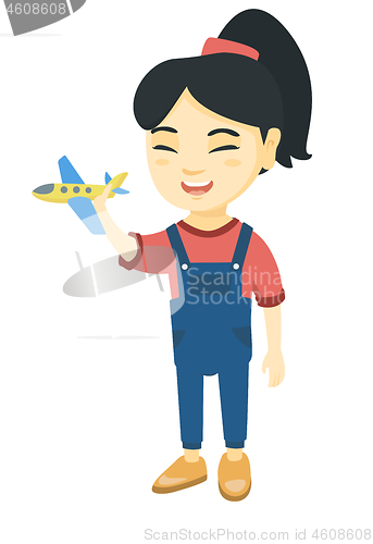 Image of Asian cheerful girl playing with a toy airplane