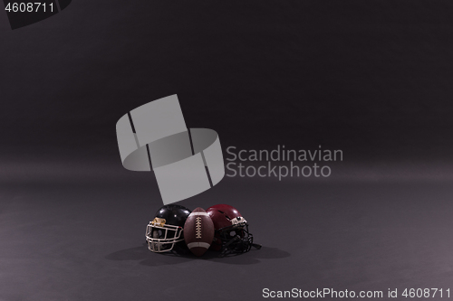 Image of american football and helmets isolated on gray