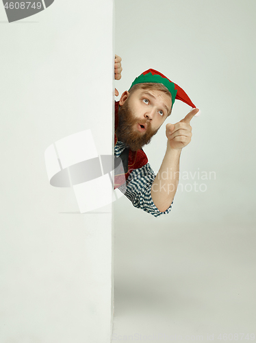 Image of friendly man dressed like a funny gnome posing on an isolated gray background