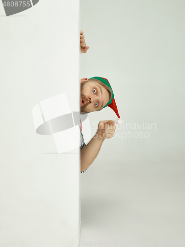 Image of friendly man dressed like a funny gnome posing on an isolated gray background