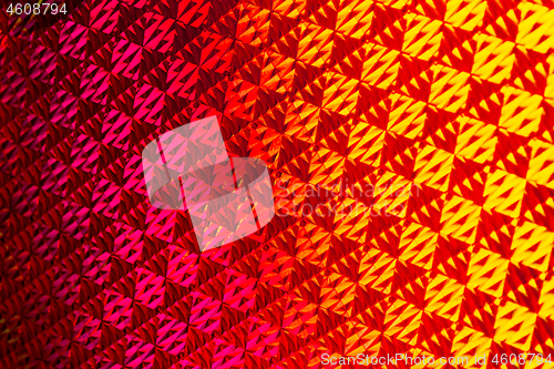 Image of Texture of red foil with holographic effect. Christmas background.