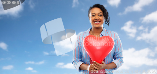 Image of african american woman with heart-shaped balloon