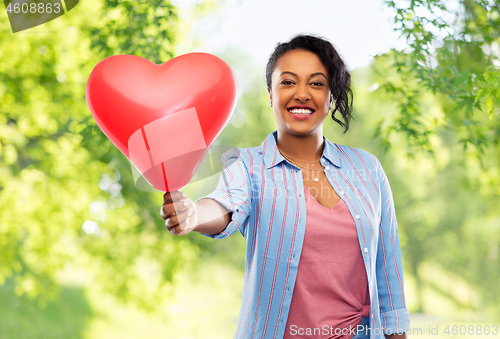 Image of african american woman with heart-shaped balloon