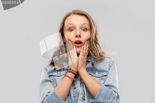 Image of surprised or scared teenage girl in red t-shirt