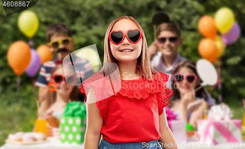 Image of girl in heart shaped sunglasses at birthday party