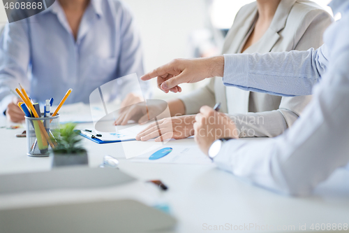 Image of business team discussing charts at office