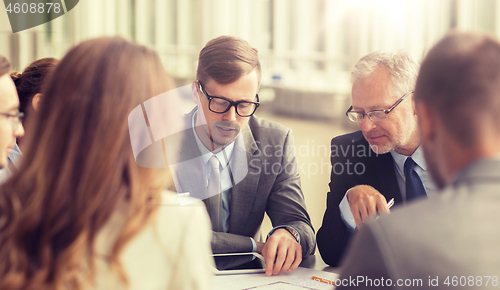 Image of architects with blueprint and tablet pc at office