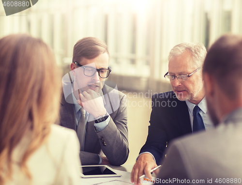 Image of architects with tablet pc and blueprint at office