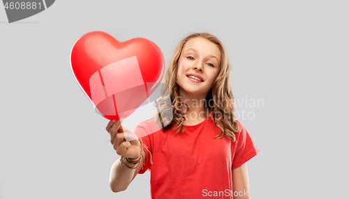 Image of smiling teenage girl with red heart shaped balloon