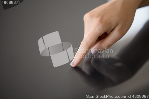 Image of hand using black interactive panel