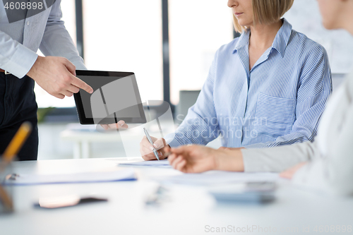 Image of close up of business team with tablet pc at office