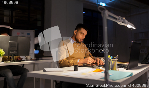 Image of man or designer with computer and tablet at office