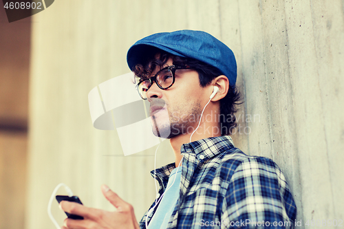 Image of man with earphones and smartphone listening music