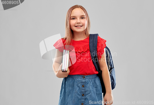 Image of smiling student girl with books and bag