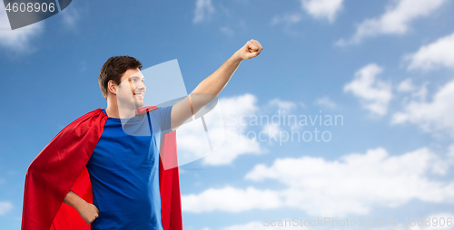 Image of man in red superhero cape over sky background