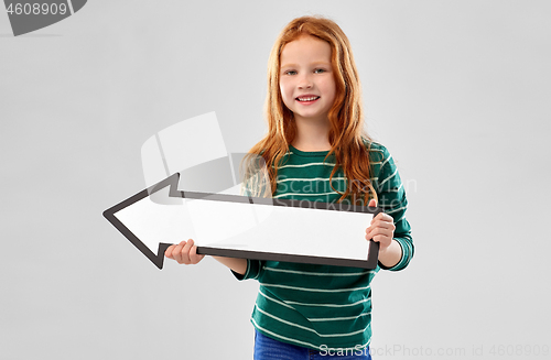 Image of smiling red haired girl with arrow showing to left