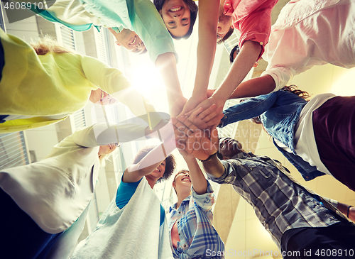 Image of group of international students with hands on top