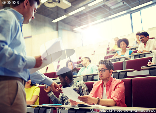 Image of teacher giving tests to students at lecture