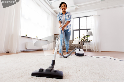 Image of woman or housewife with vacuum cleaner at home