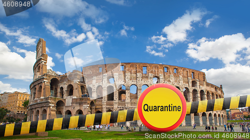 Image of Prohibition yellow sign of quarantine on the background of Colosseum in Rome City, Italy.