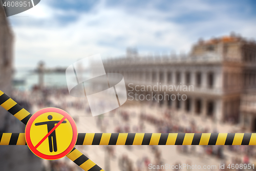 Image of Crossing fencing lines and warning sign with crossed out man on the blurred background of Doge\'s Palace in Venice, Italy.