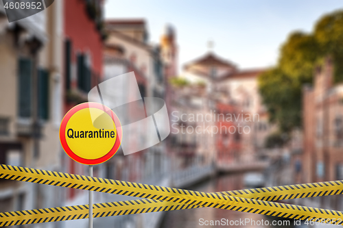 Image of Forbidden sign of quarantine with crossing police lines on a blurred background of Grand Canal in Venice, Italy.