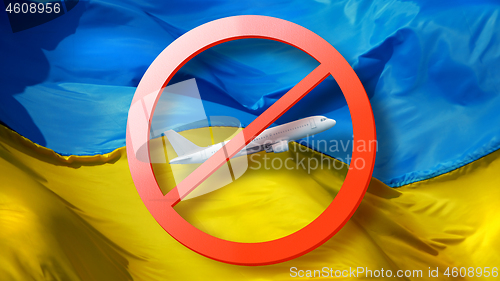 Image of Close-up prohibition sign with crossed out white plane on the background of Ukrainian flag.