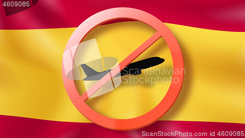 Image of Warning sign with crossed out plane on the background of Spanish flag.