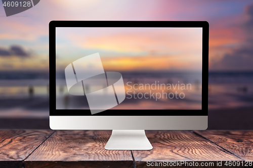 Image of Computer screen with blurred sea background.