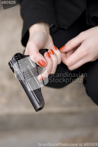 Image of gun in female hands