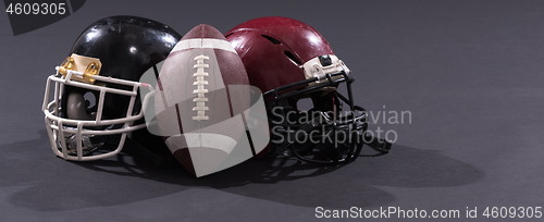 Image of american football and helmets isolated on gray