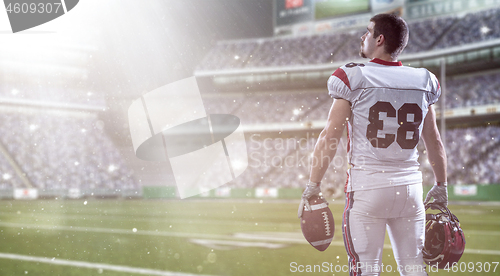 Image of American Football Player isolated on big modern stadium field