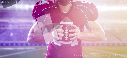 Image of American Football Player isolated on big modern stadium field