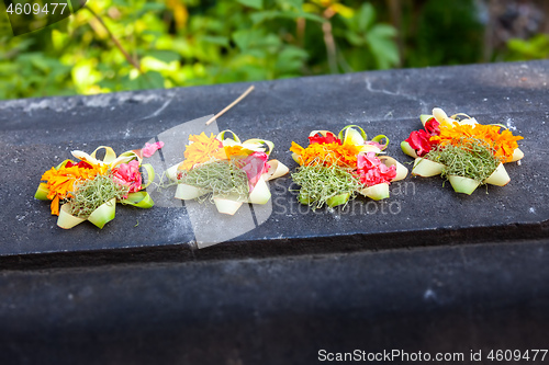 Image of Votive offering with flowers, cookies and ribbons