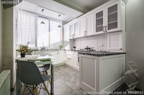 Image of Modern white kitchen interior, front view