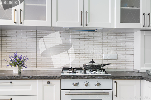 Image of Modern white kitchen interior, front view