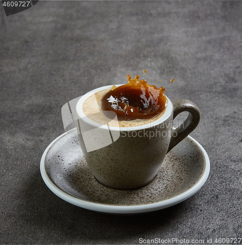 Image of coffee splashing in a cup