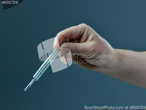 Image of hand with thermometer