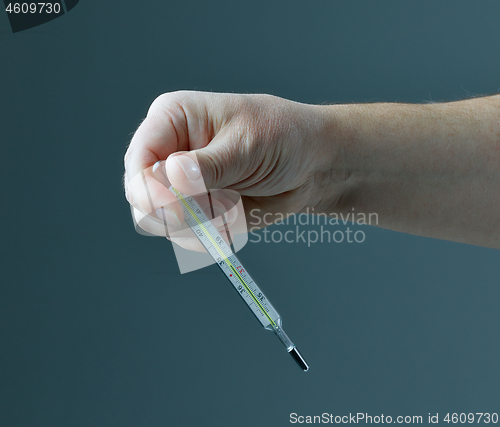 Image of thermometer in human hand