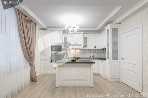 Image of White luxury modern kitchen with island