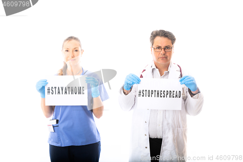 Image of Doctors hold warning signs during Coronavirus COVID-19 virus pan