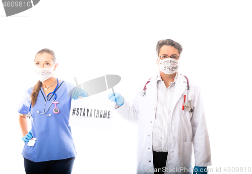 Image of Two medical staff hold a sign during Coronavirus COVID-19 pandem