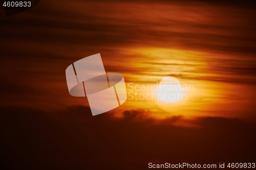 Image of Sunset through cloudy red sky