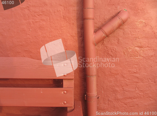 Image of Detail of bench, pipe & wall