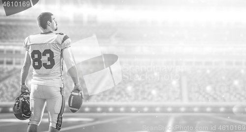 Image of American Football Player isolated on big modern stadium field